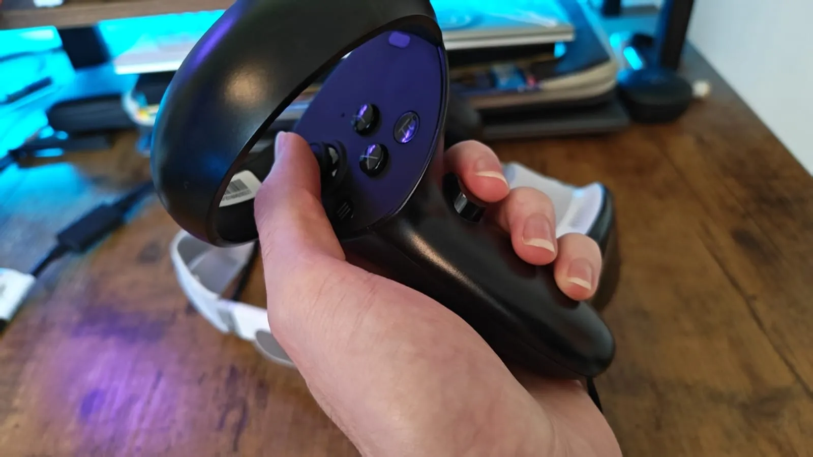 A reviewer holding the controller for the Pimax Dream Air