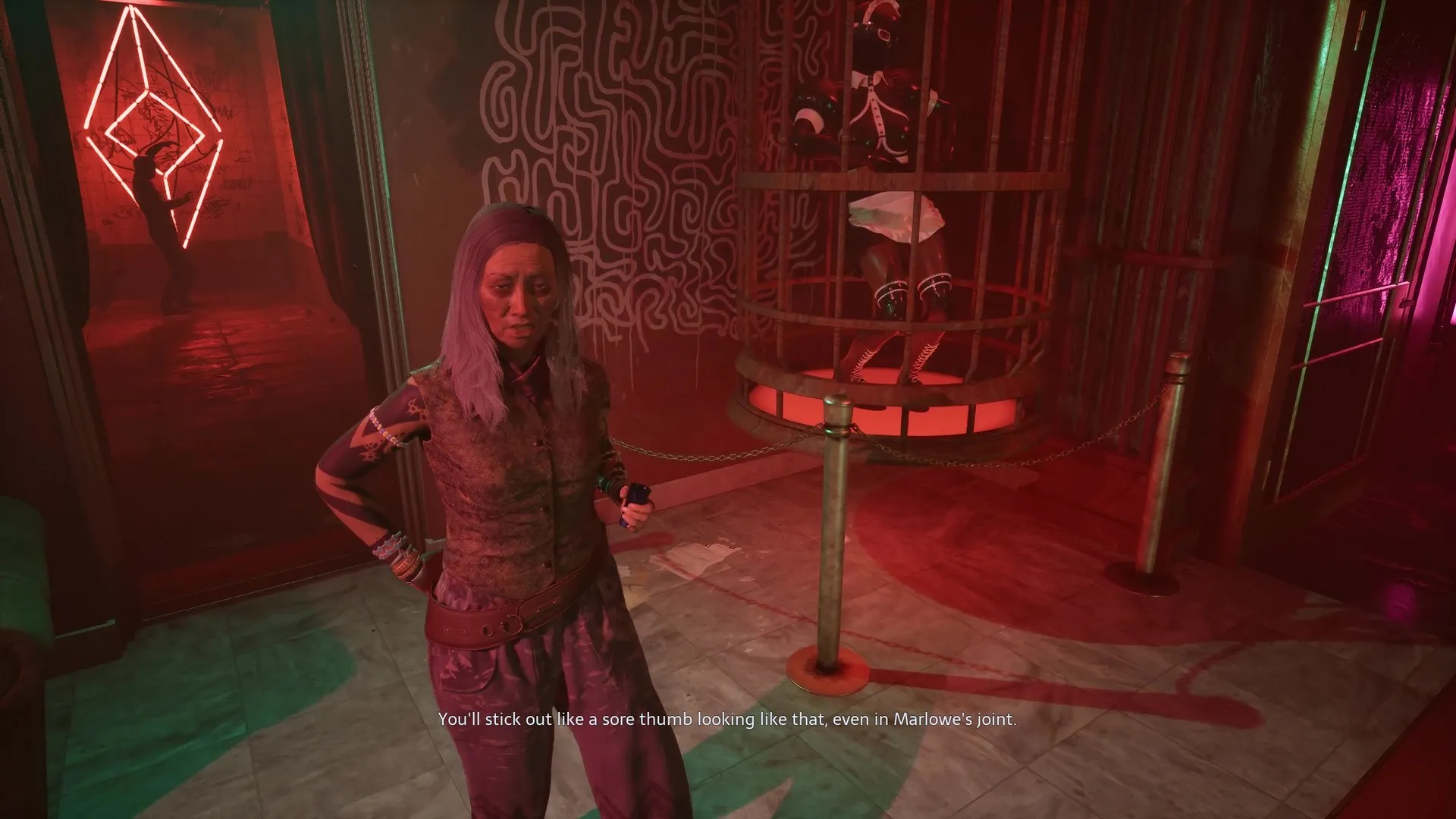 Zora speaks with Aiden in Marlowe's club as a nearby dancer gyrates in Hellraiser: Revival