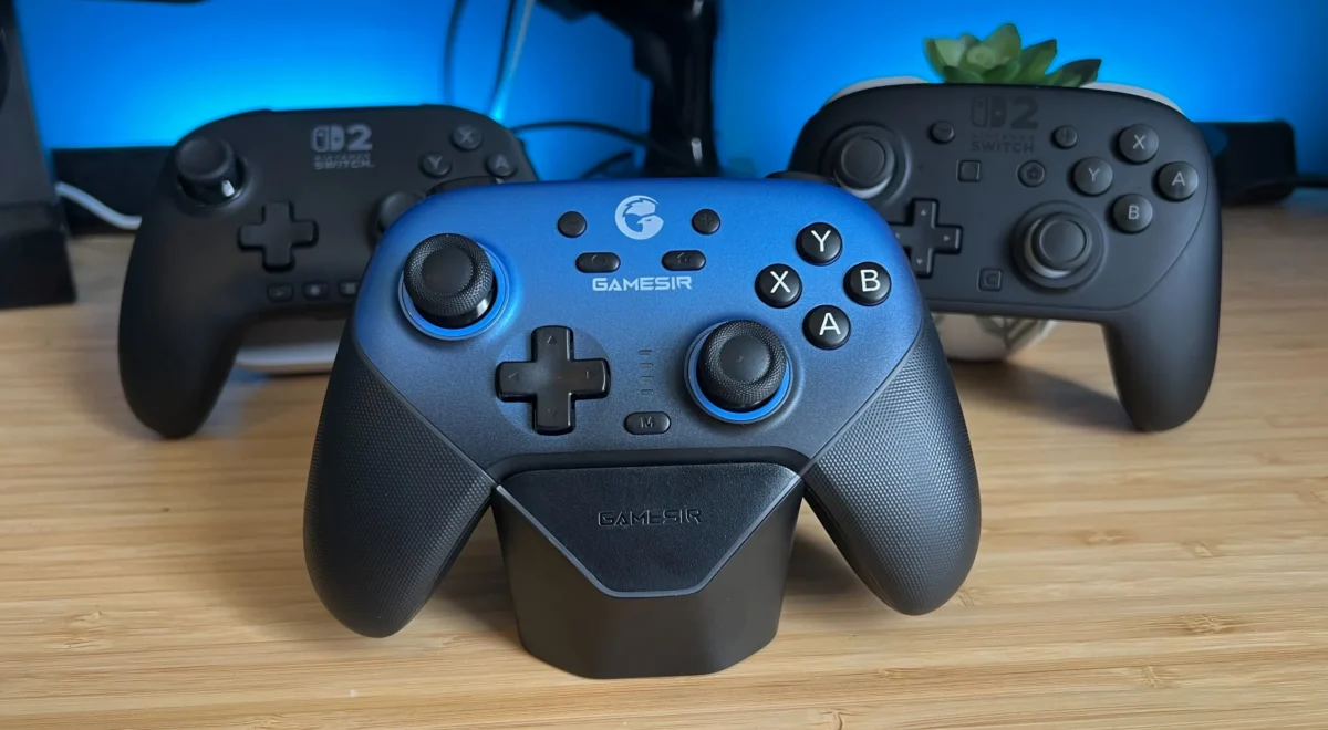 UondU7jCVAz24bEjDihdTG.jpg GameSir Super Nova controller on a wooden desk with PowerA Advantage Wired Controller and Nintendo Switch 2 Pro Controller behind it