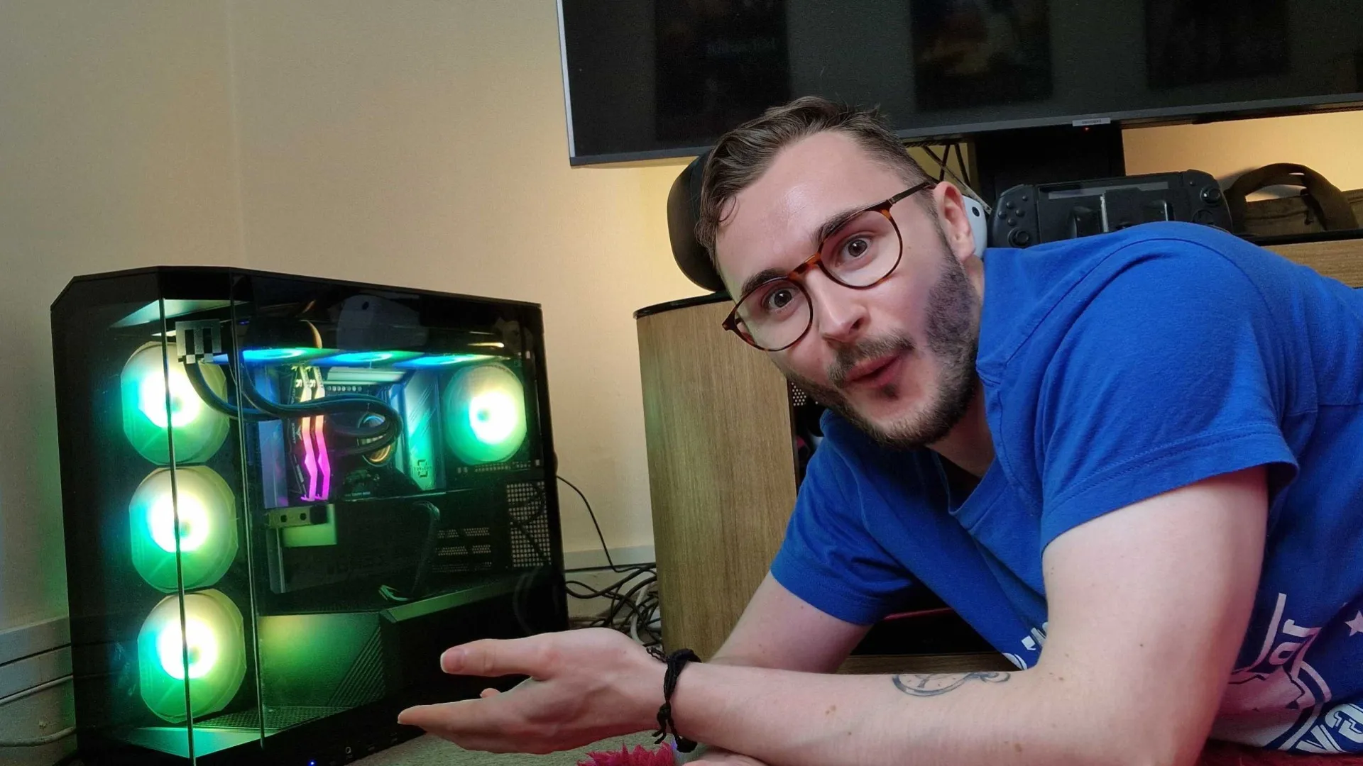 Hardware Editor Duncan Robertson posing with an RGB lit gaming PC